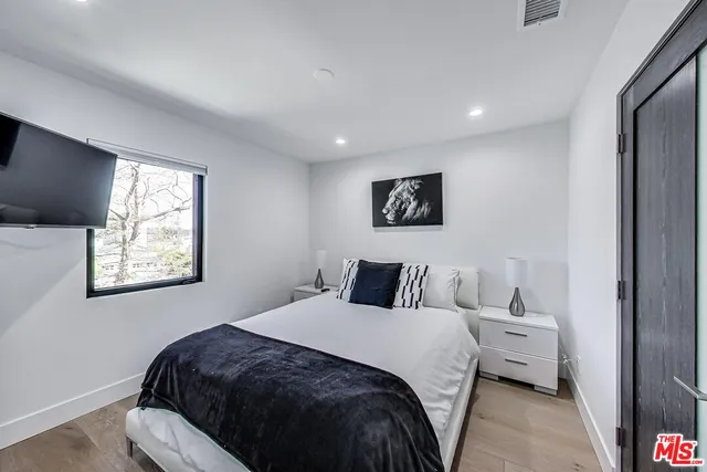 a bedroom with a large bed and a window