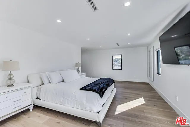a large white bed in a white room