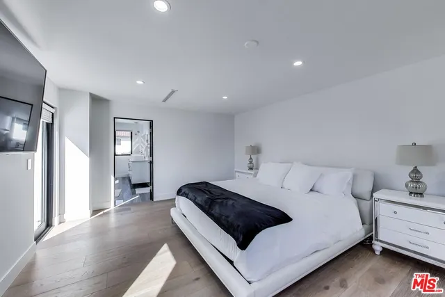 a bedroom with a bed and a view of bathroom