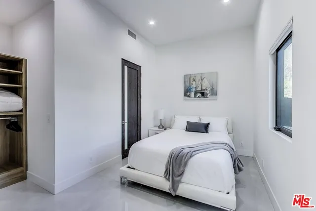 a bedroom with a bed and a tv