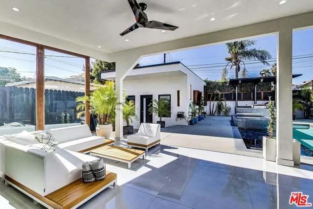 a living room with fireplace furniture and a large window