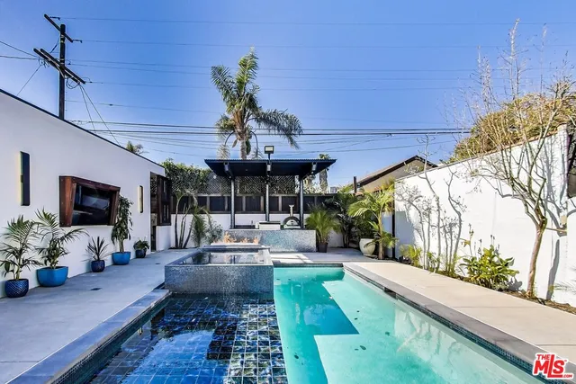 a living room with patio furniture and a fireplace