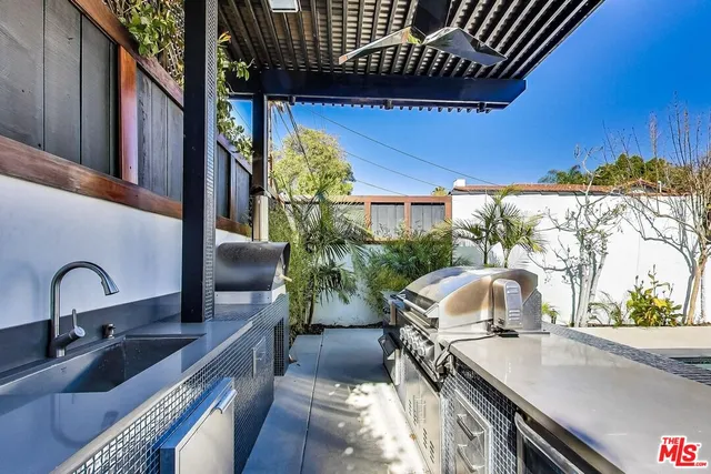 a kitchen view with a sink and outdoor seating