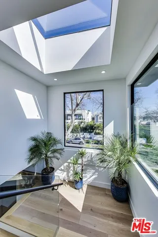 a vase of flowers sitting on a table in front of a window