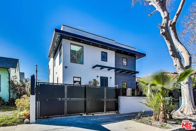 a front view of a house with plants