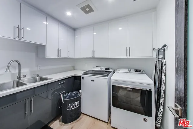 a view of a kitchen with sink washer and dryer