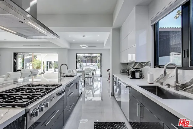 a kitchen with sink stove and cabinets