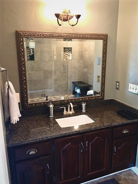 2445 Ravine Drive Nashville, TN 37217 - Photo 17 of 26 a bathroom with a granite countertop sink a mirror and shower
