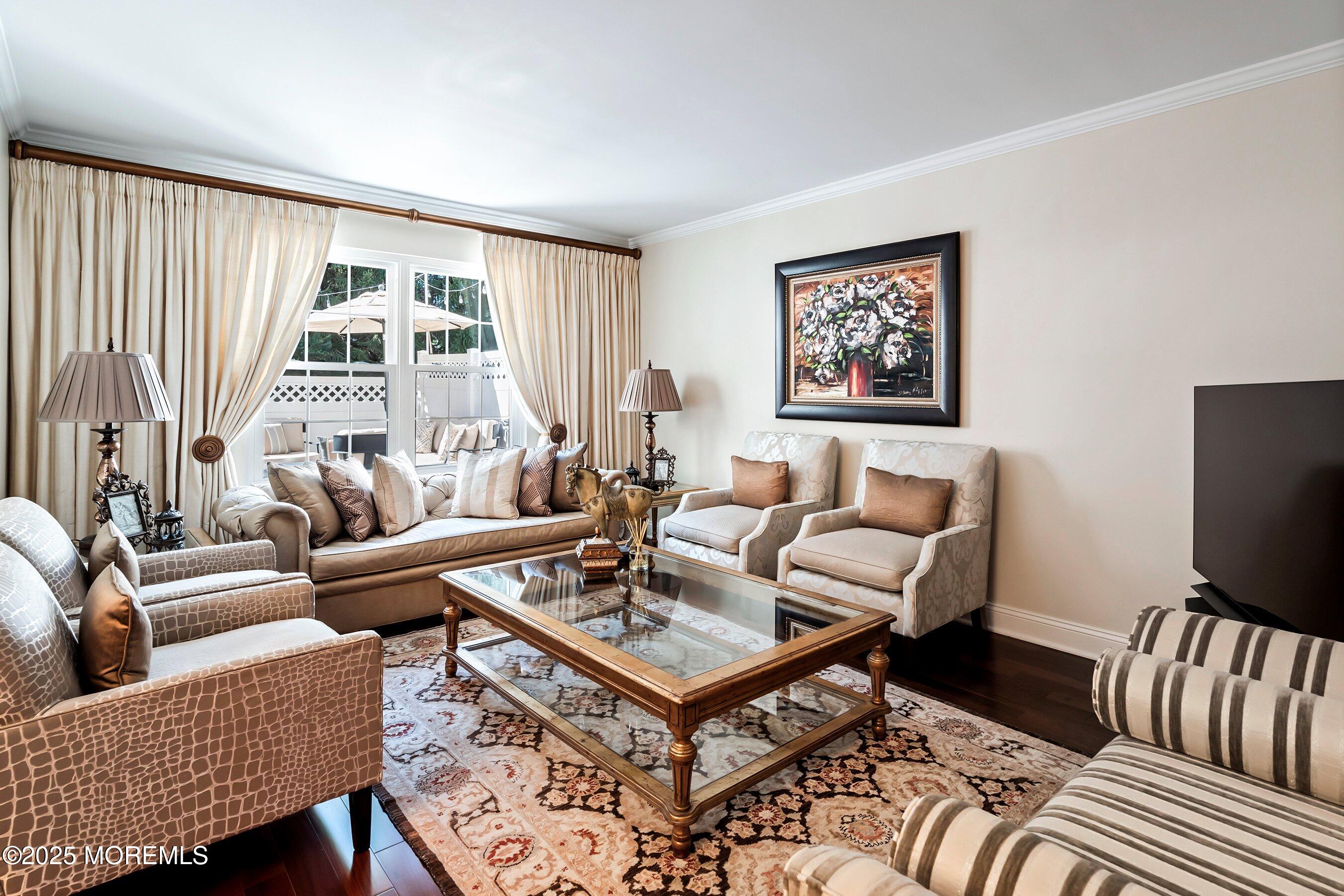 32 Bristel Road, Unit 212 Holmdel, NJ 07733 - Photo 11 of 61 a living room with furniture a flat screen tv and a window