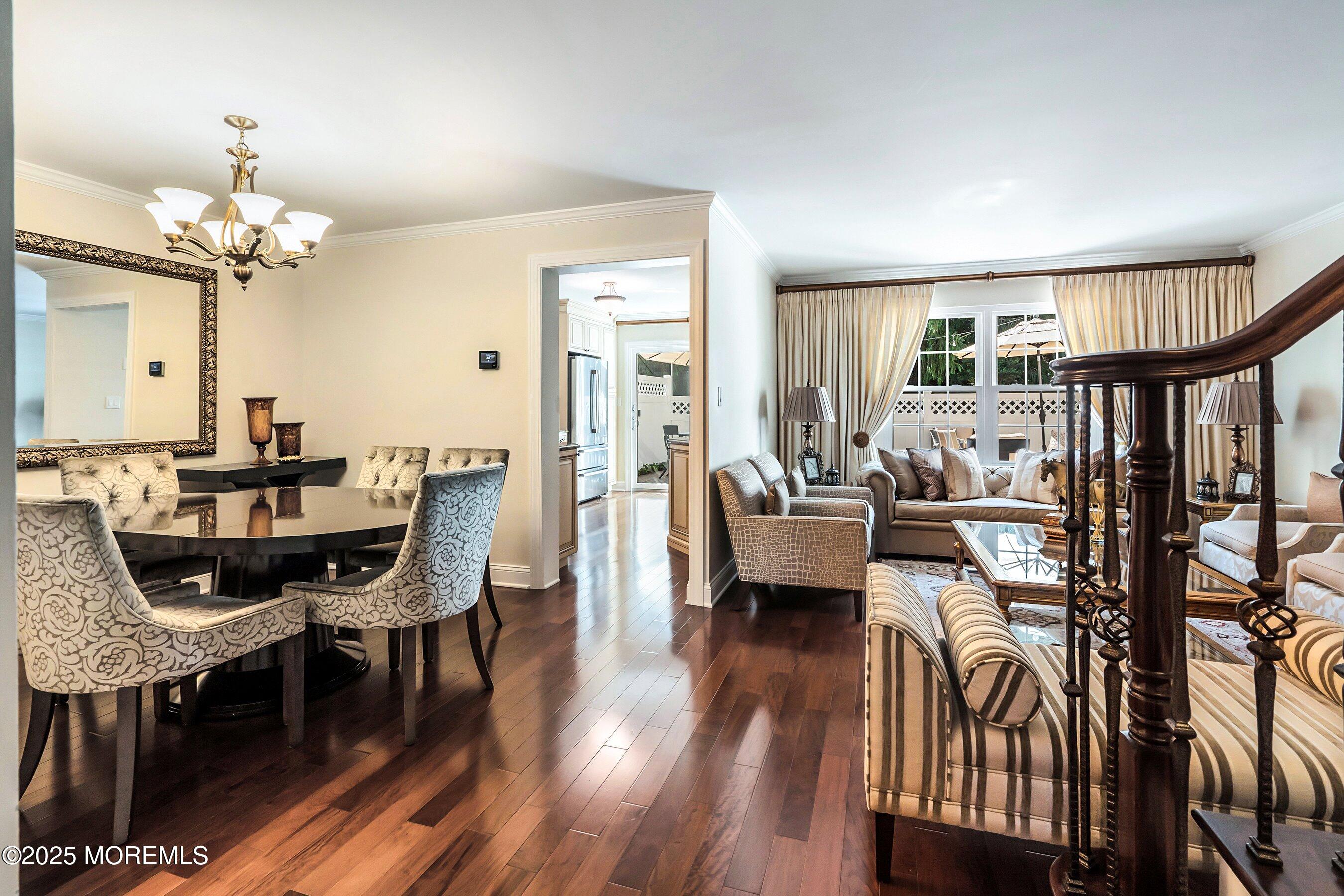 32 Bristel Road, Unit 212 Holmdel, NJ 07733 - Photo 12 of 61 a view of a dining room with furniture a chandelier and wooden floor