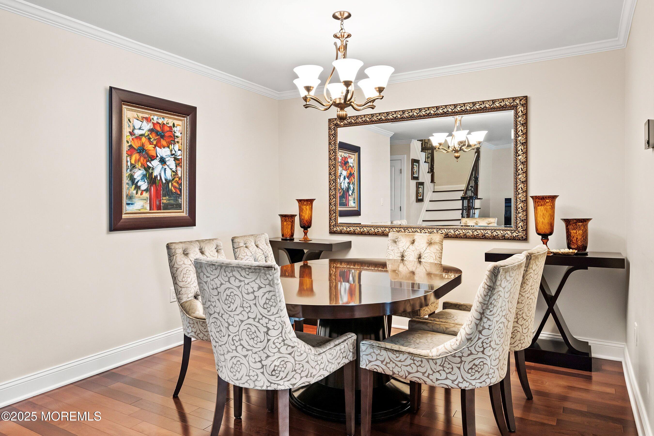 32 Bristel Road, Unit 212 Holmdel, NJ 07733 - Photo 13 of 61 a view of a dining room with furniture and wooden floor