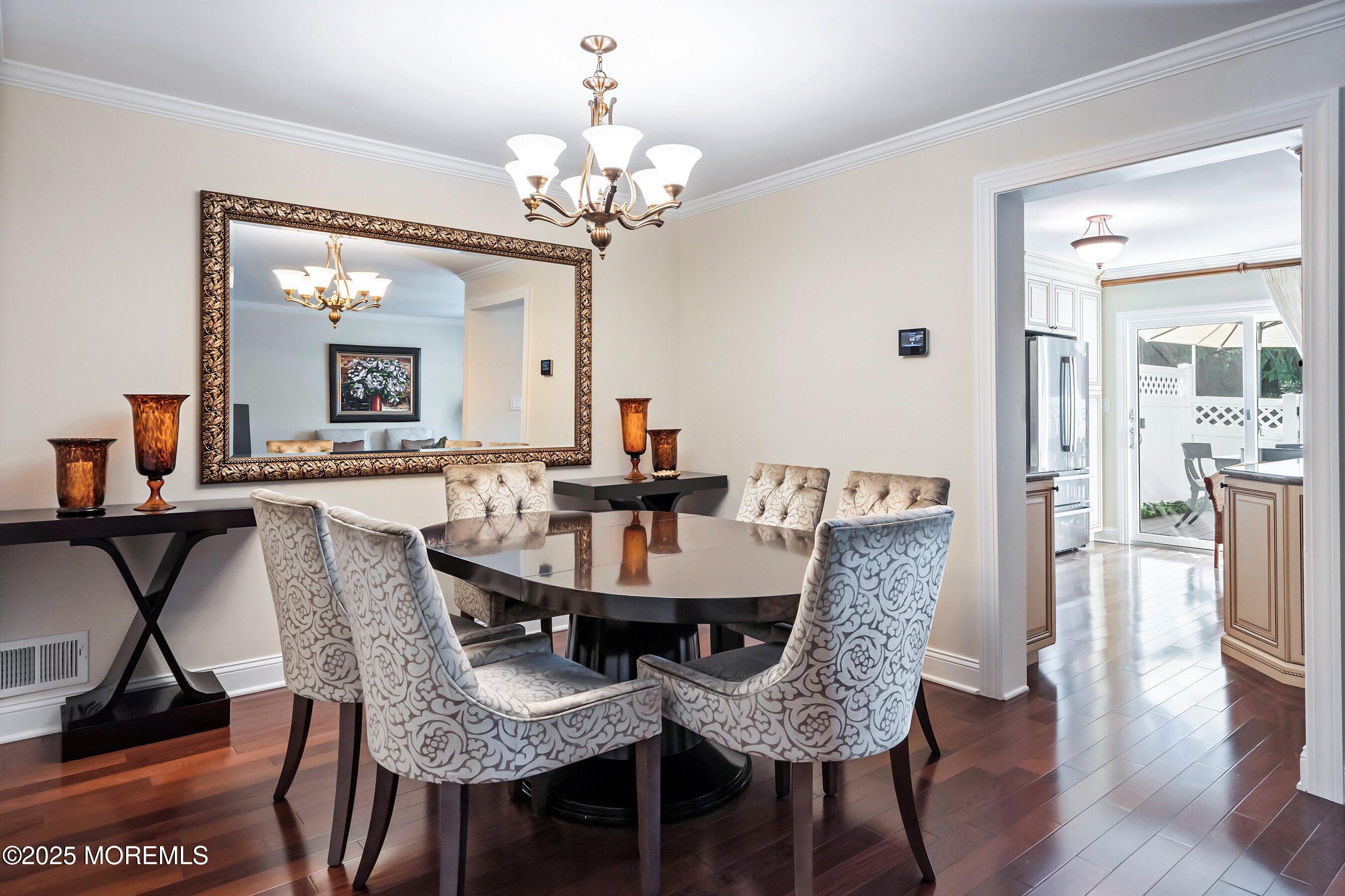 32 Bristel Road, Unit 212 Holmdel, NJ 07733 - Photo 14 of 61 a view of a dining room with furniture and wooden floor