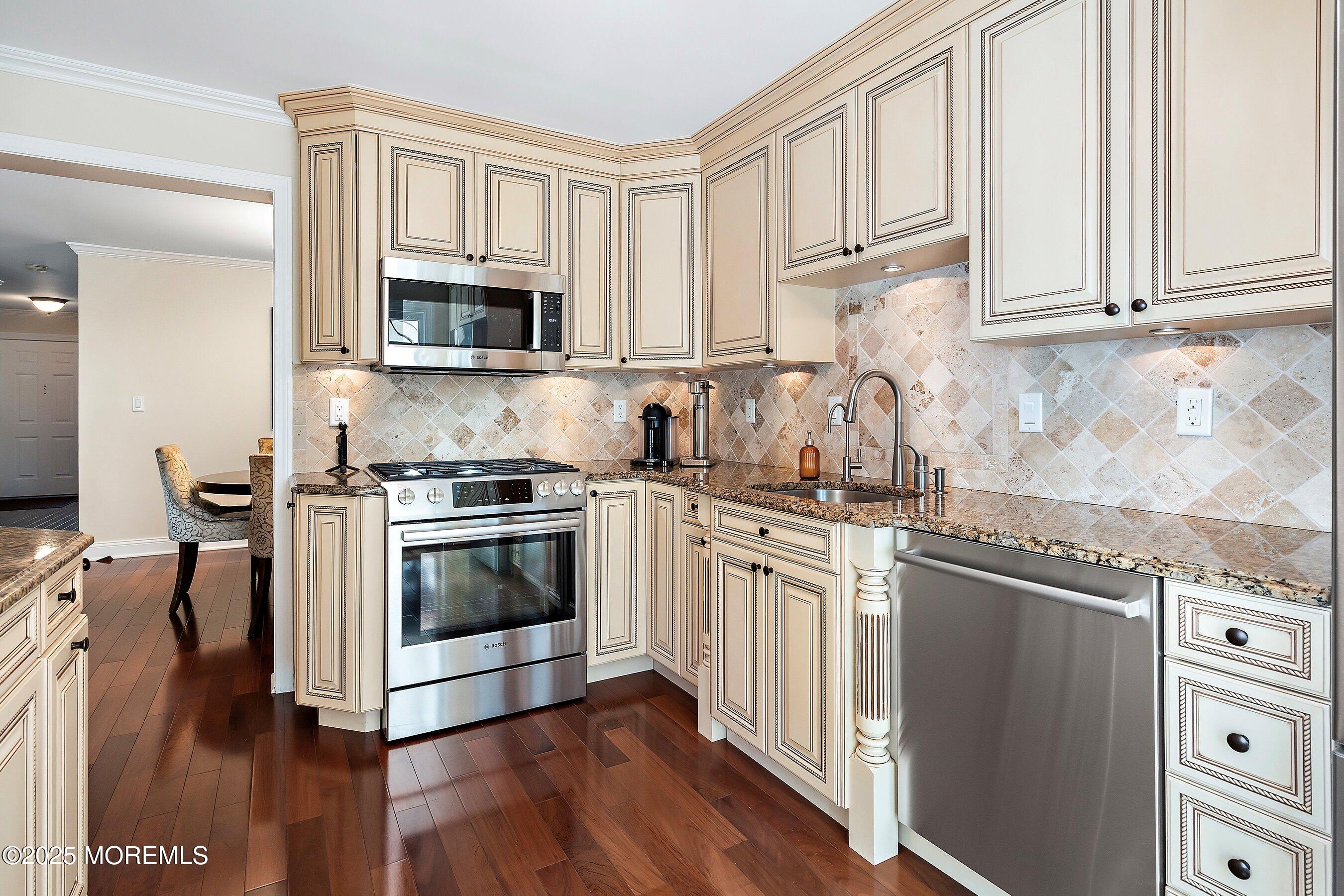 32 Bristel Road, Unit 212 Holmdel, NJ 07733 - Photo 19 of 61 a kitchen with stainless steel appliances granite countertop a stove a sink and a microwave