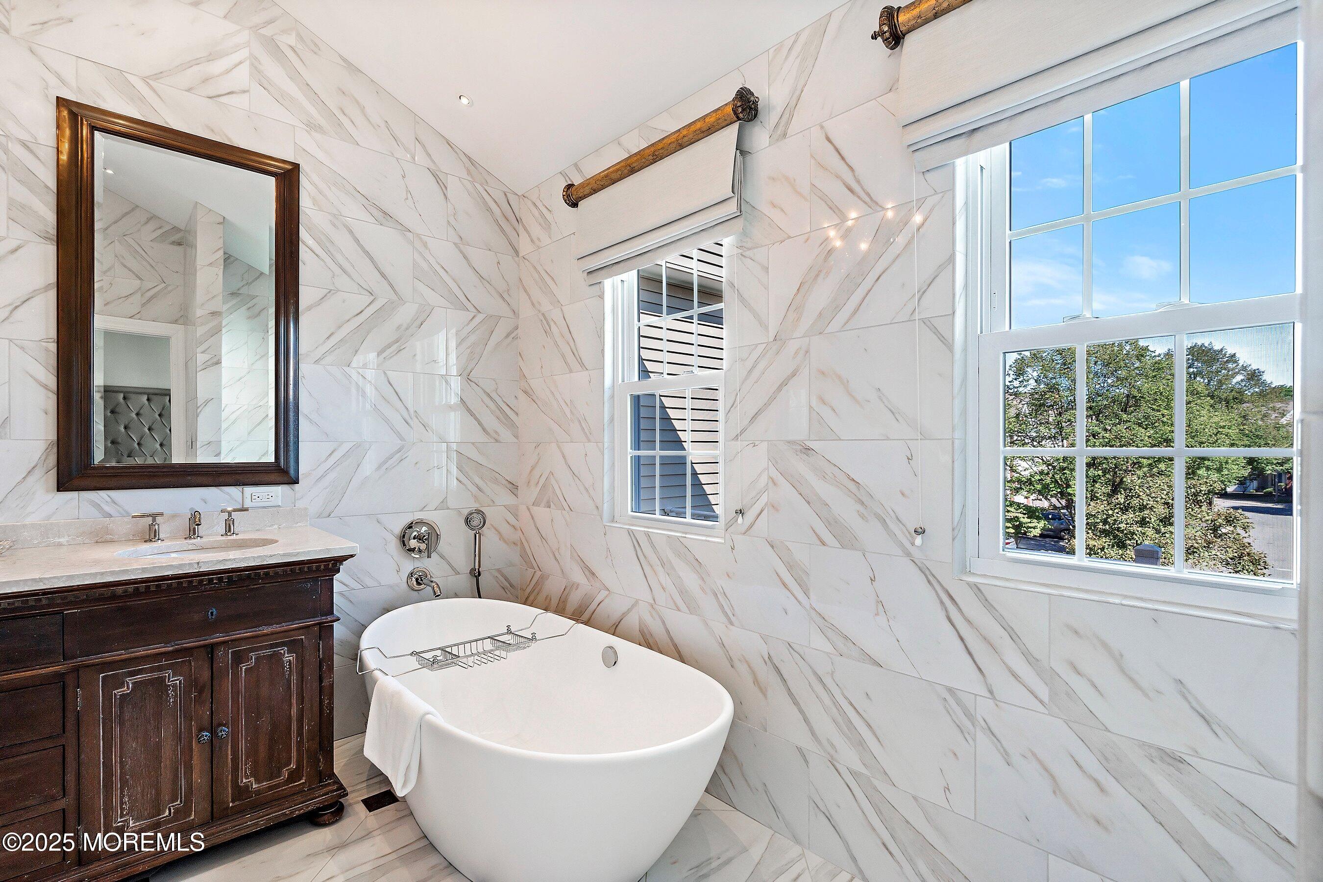 32 Bristel Road, Unit 212 Holmdel, NJ 07733 - Photo 29 of 61 a bathroom with a sink and mirror with bathtub