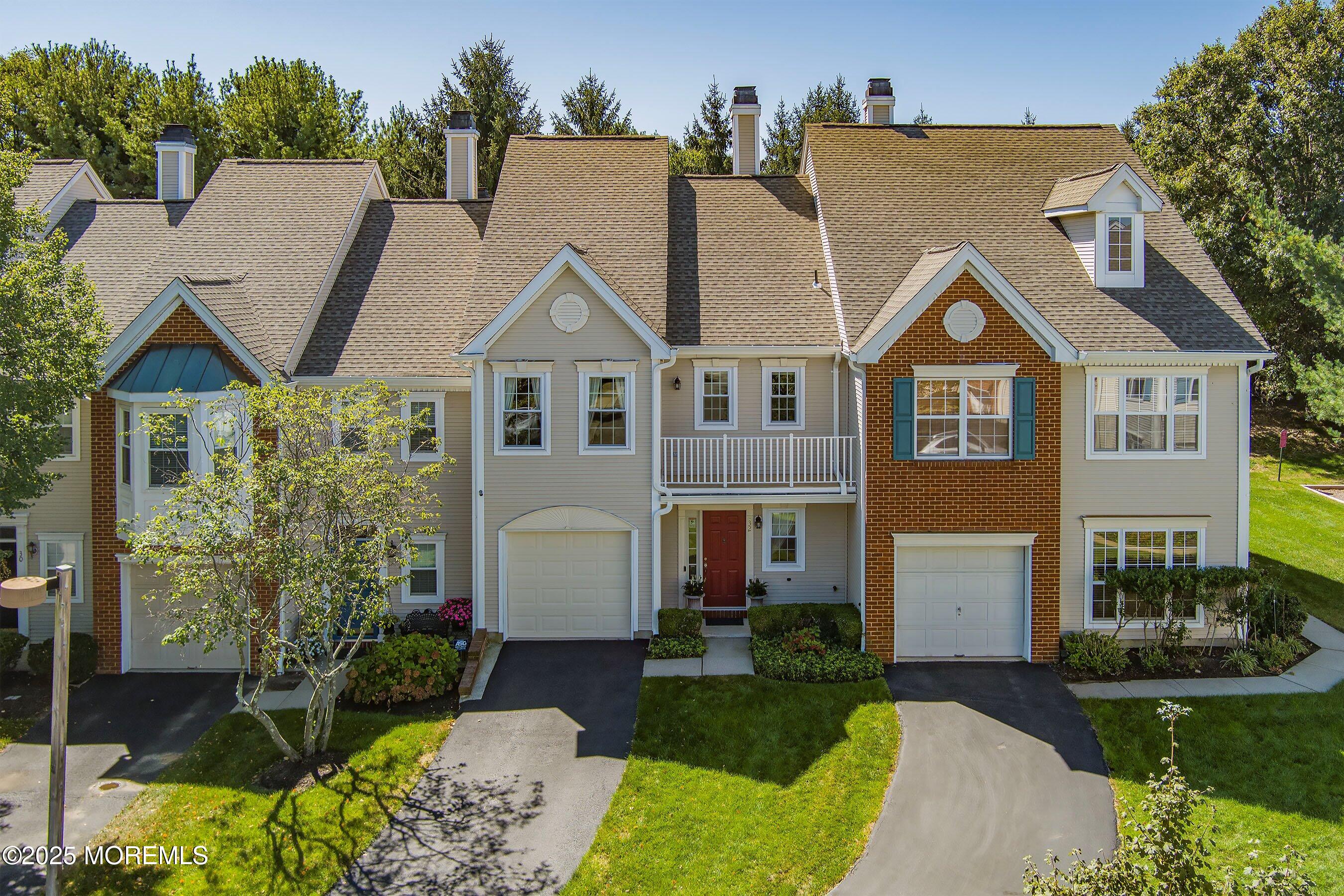 32 Bristel Road, Unit 212 Holmdel, NJ 07733 - Photo 3 of 61 a view of a white house next to a yard with big trees