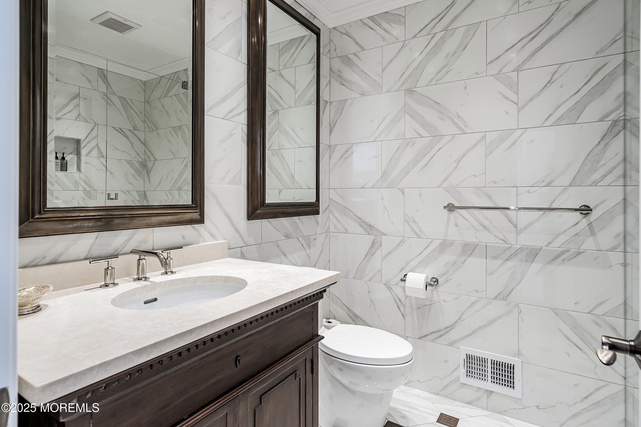 32 Bristel Road, Unit 212 Holmdel, NJ 07733 - Photo 34 of 61 a bathroom with a sink mirror and toilet