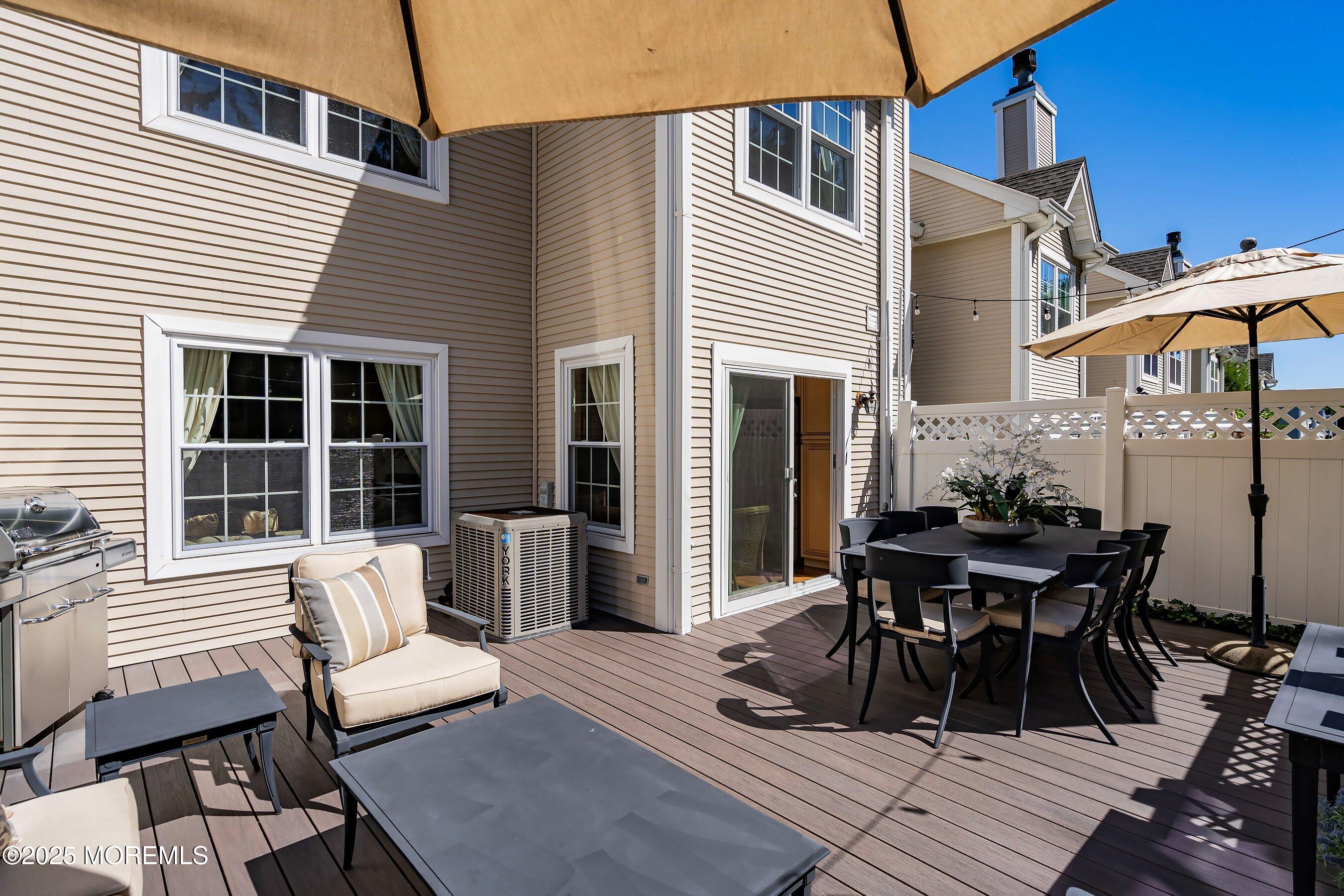 32 Bristel Road, Unit 212 Holmdel, NJ 07733 - Photo 45 of 61 a view of a dinning table and chairs in the patio