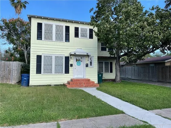 a front view of house with yard and outdoor seating