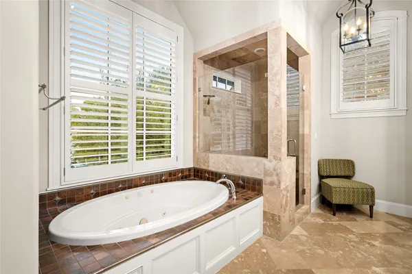 a bath tub sitting in a bathroom next to a window
