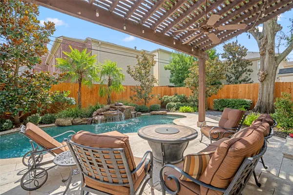 a view of an outdoor sitting area with furniture and garden view