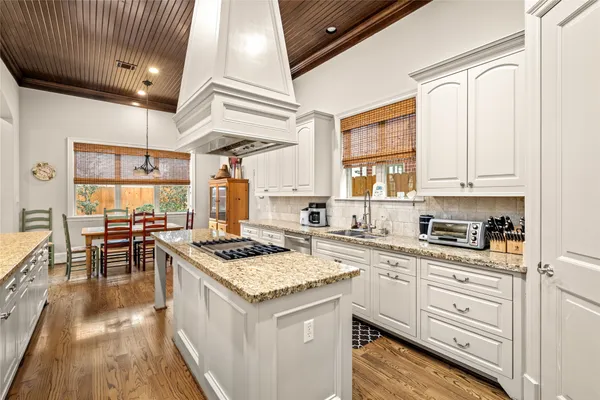 a kitchen with stainless steel appliances granite countertop a stove and a sink