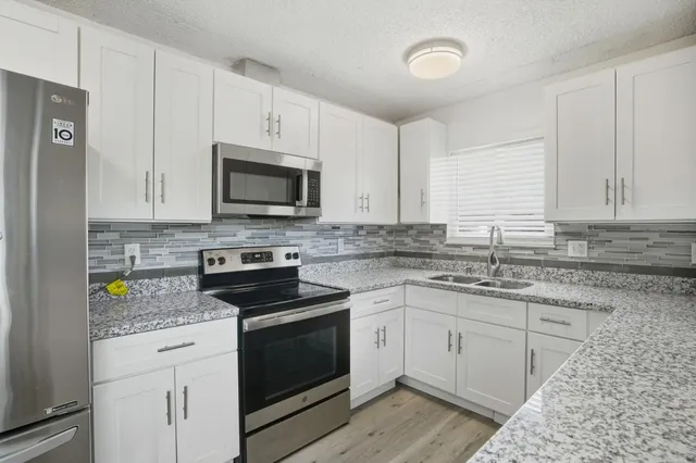 an empty room with a cabinet and mirrors