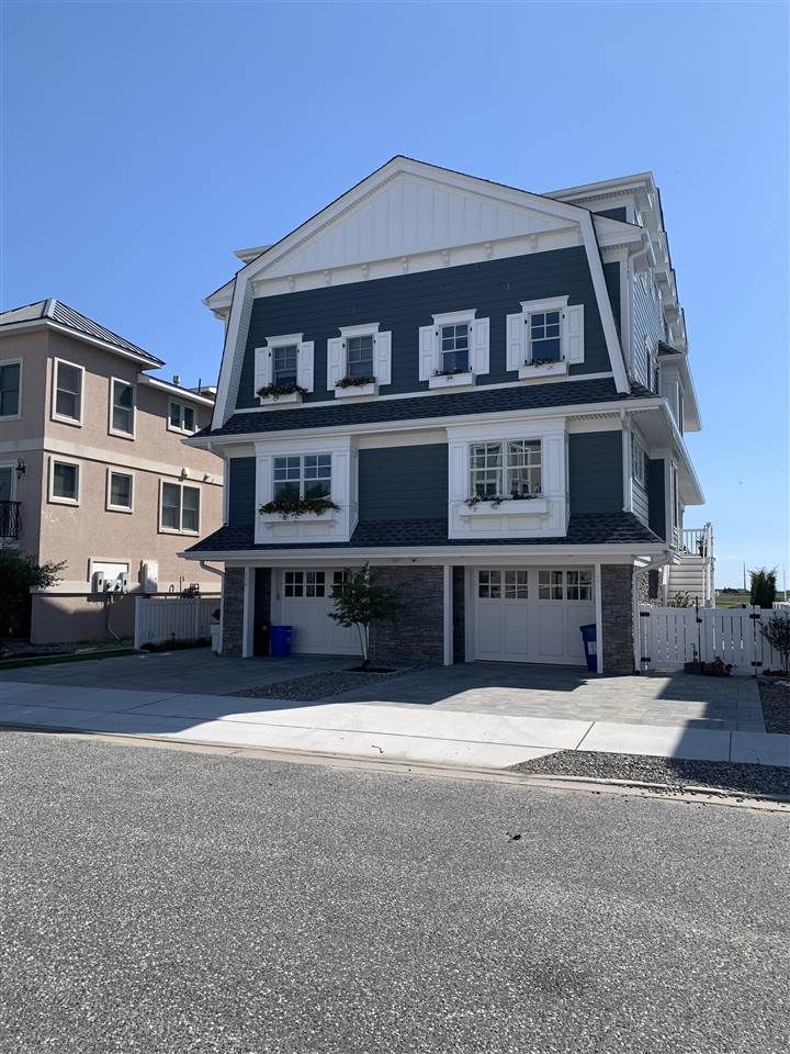 692 22nd, Unit WEST Avalon, NJ 08202 - Photo 2 of 6 a front view of a house with a yard