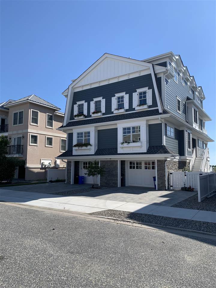692 22nd, Unit WEST Avalon, NJ 08202 - Photo 3 of 6 a front view of a building with a lot of windows