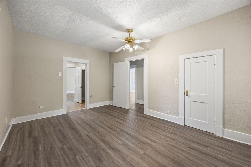 705 Madison Street Cleburne, TX 76033 - Photo 19 of 26 wooden floor in an empty room with a window