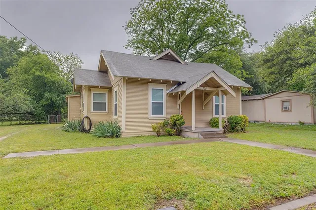 a front view of house with yard and green space