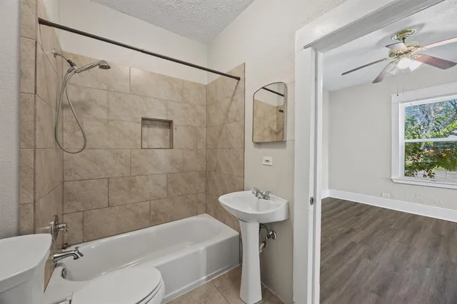a bathroom with a toilet and shower
