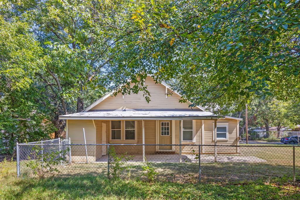 705 Madison Street Cleburne, TX 76033 - Photo 25 of 26 a front view of a house with garden