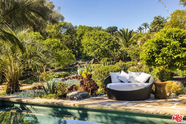 a view of a yard with an outdoor seating