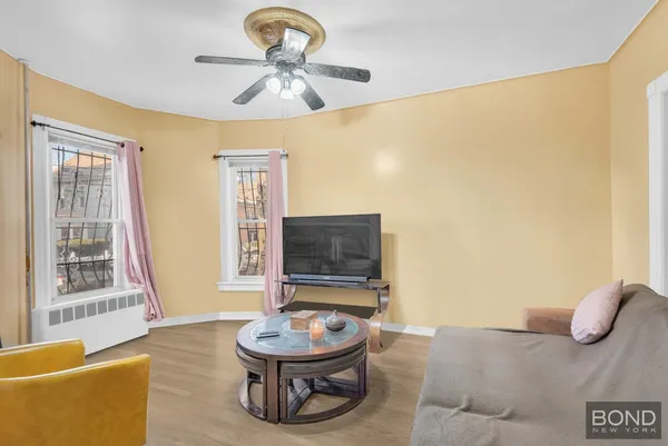 a living room with furniture and a wooden floor