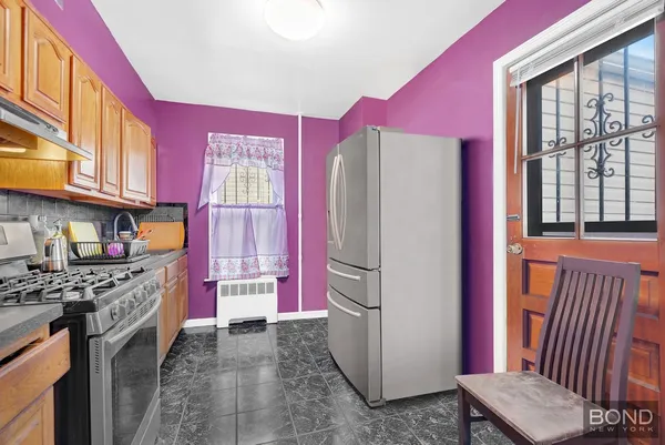 a kitchen with stainless steel appliances granite countertop a refrigerator and a stove