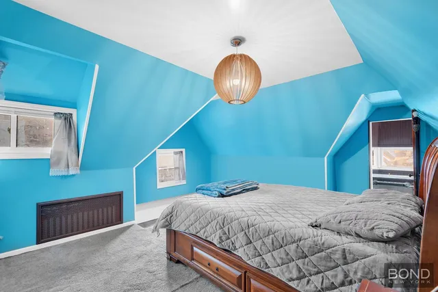 a bedroom with a large bed and a large mirror