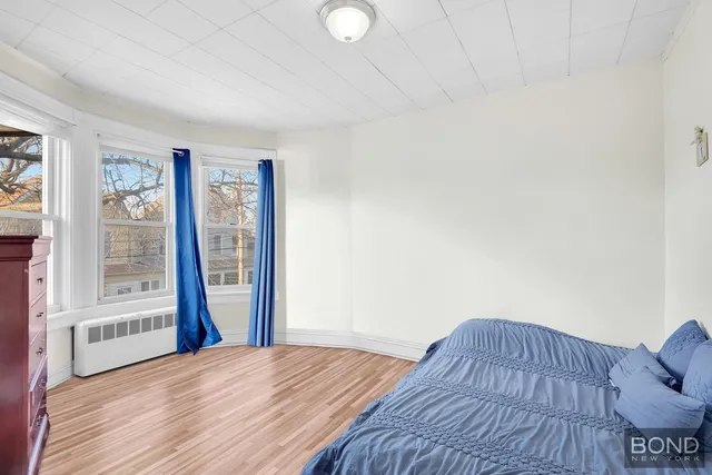 a view of a livingroom with wooden floor and furniture