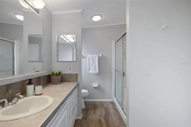 a bathroom with a sink and mirror with toilet