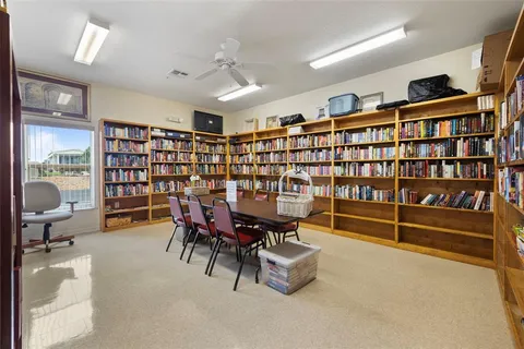 a reading room with furniture and book shelf