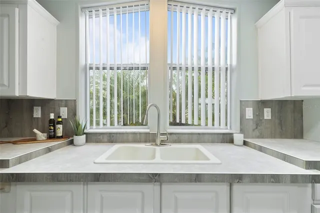 a kitchen with a sink cabinets and a window