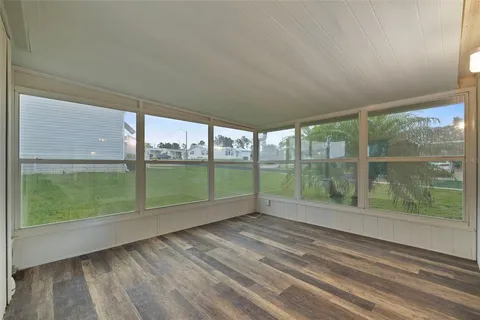 a view of outdoor space with wooden floor and windows