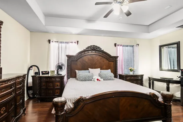 a bedroom with a bed and dresser with mirror