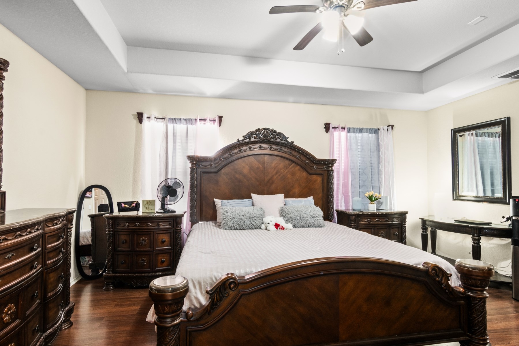 18823 Appletree Ridge Road Houston, TX 77084 - Photo 11 of 22 a bedroom with a bed and dresser with mirror