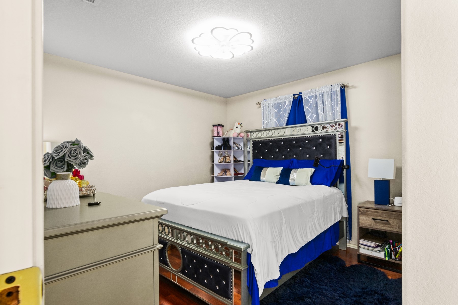 18823 Appletree Ridge Road Houston, TX 77084 - Photo 15 of 22 a bedroom with a bed and a potted plant on the dresser