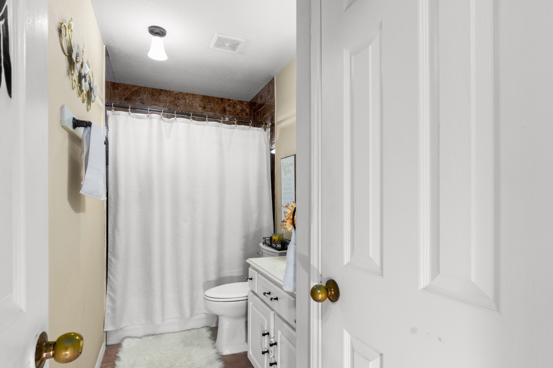 18823 Appletree Ridge Road Houston, TX 77084 - Photo 16 of 22 a bathroom with a shower curtain and a toilet