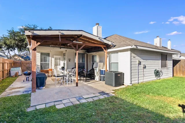 a view of a house with yard and sitting area