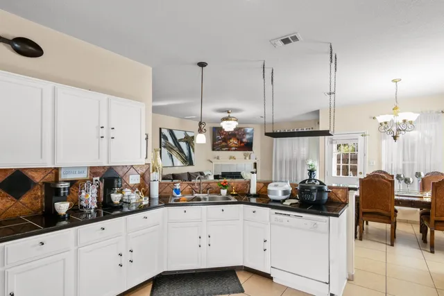 a kitchen with stainless steel appliances granite countertop a sink and cabinets