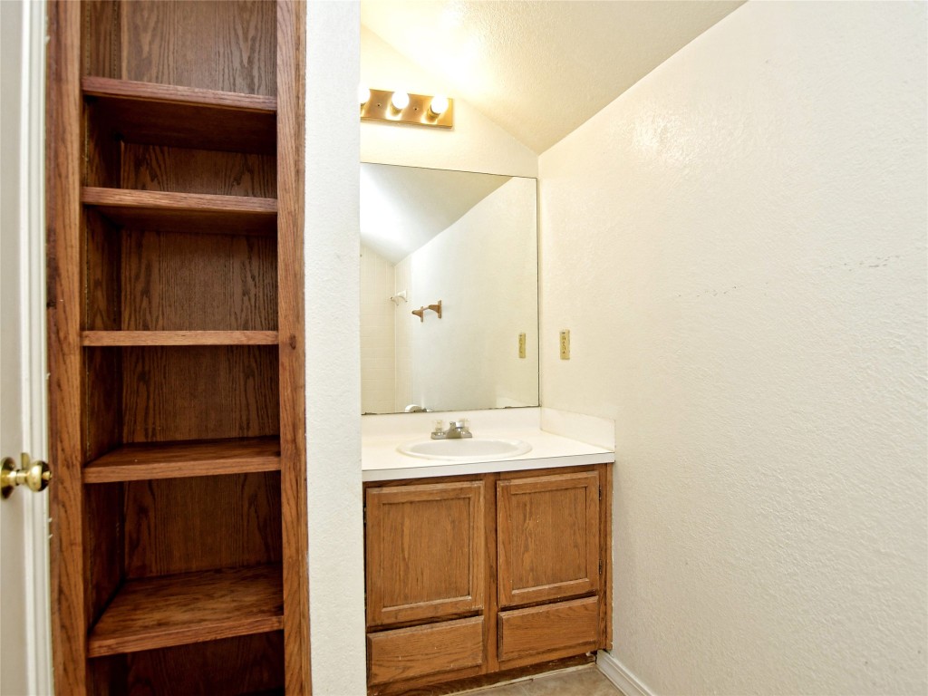 803 Valley View Drive, Unit B Pflugerville, TX 78660 - Photo 13 of 22 a bathroom with a sink and a mirror
