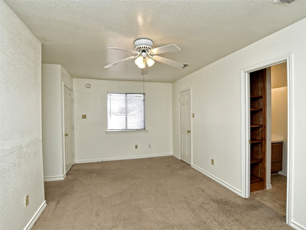 803 Valley View Drive, Unit B Pflugerville, TX 78660 - Photo 14 of 22 a view of room with window and ceiling fan