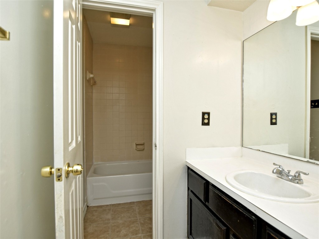 803 Valley View Drive, Unit B Pflugerville, TX 78660 - Photo 15 of 22 a bathroom with a sink and a mirror